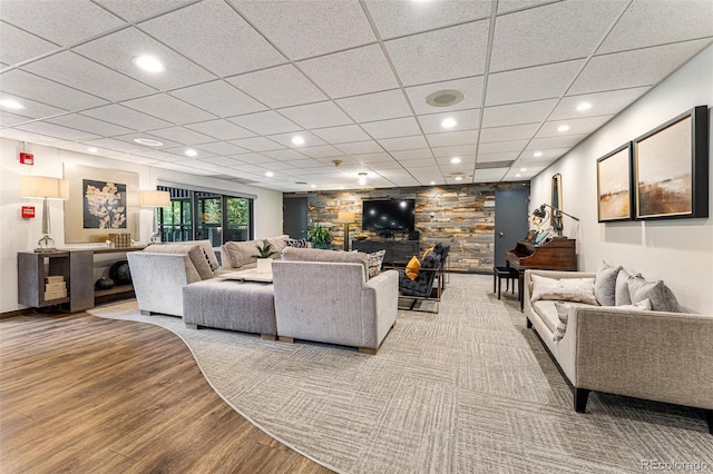 460 S Marion Pkwy Unit 801, Denver, CO 80209 - living room featuring a stone fireplace, wood finished floors, recessed lighting, and a drop ceiling