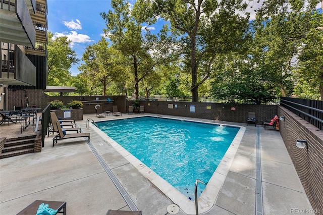 460 S Marion Pkwy Unit 801, Denver, CO 80209 - community pool featuring a patio, a fenced backyard, and view of scattered trees