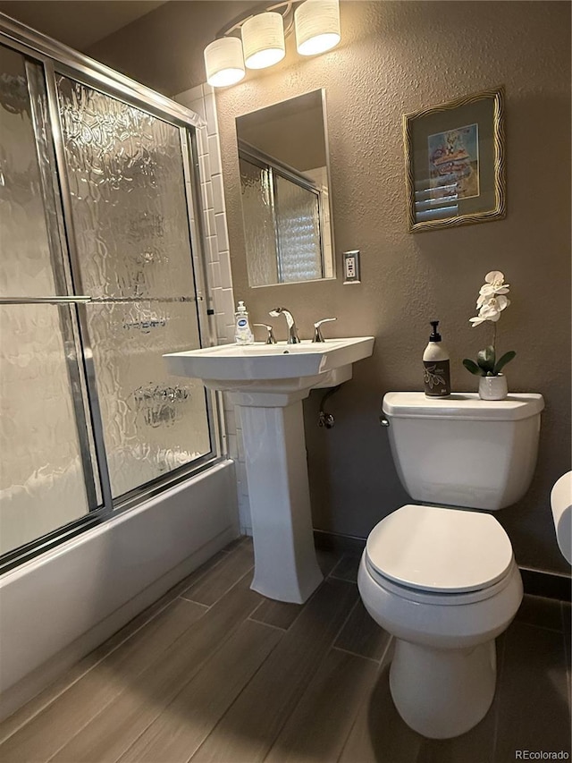 5416 S Lakeview St, Littleton, CO 80120 - bathroom featuring enclosed tub / shower combo and wood finished floors