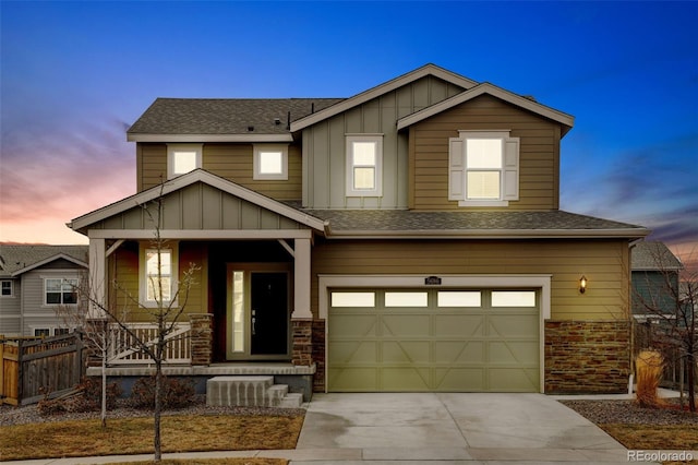 view of front of property featuring covered porch, an attached garage, board and batten siding, fence, and driveway