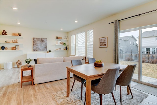 dining area with light wood-style floors and recessed lighting