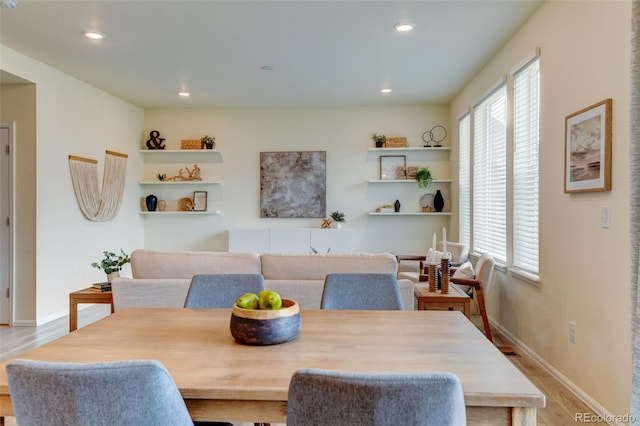 dining area featuring a wealth of natural light, wood finished floors, and recessed lighting