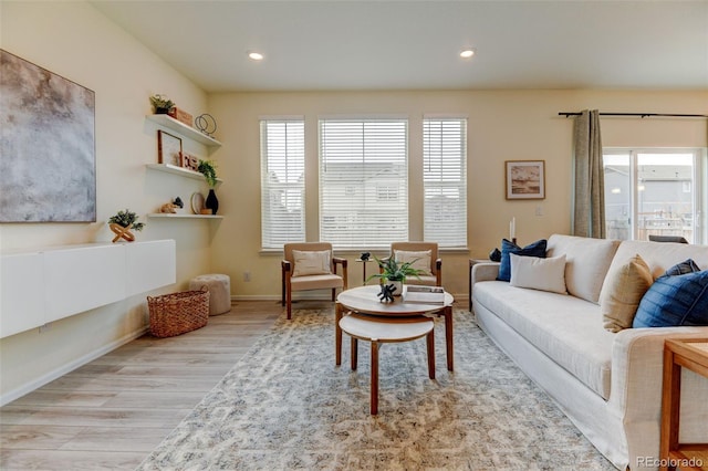 living room with baseboards, wood finished floors, and recessed lighting