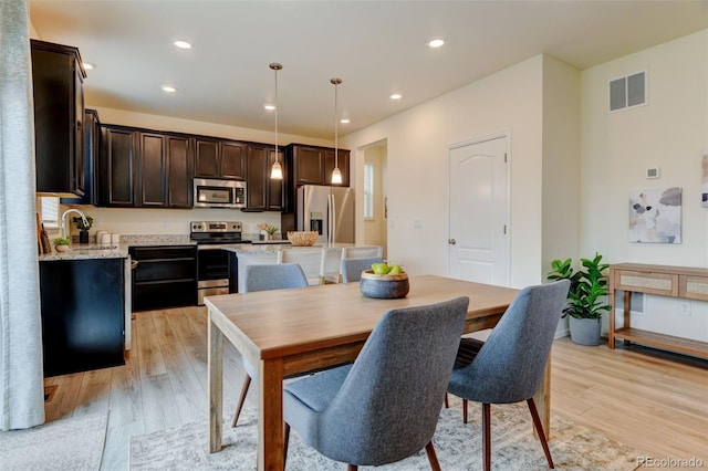 dining room with recessed lighting, visible vents, and light wood-style floors