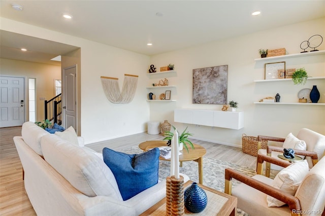 living area with baseboards, stairway, wood finished floors, and recessed lighting