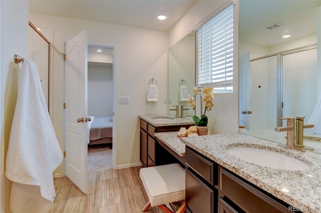 full bathroom with tiled shower, a sink, visible vents, and connected bathroom