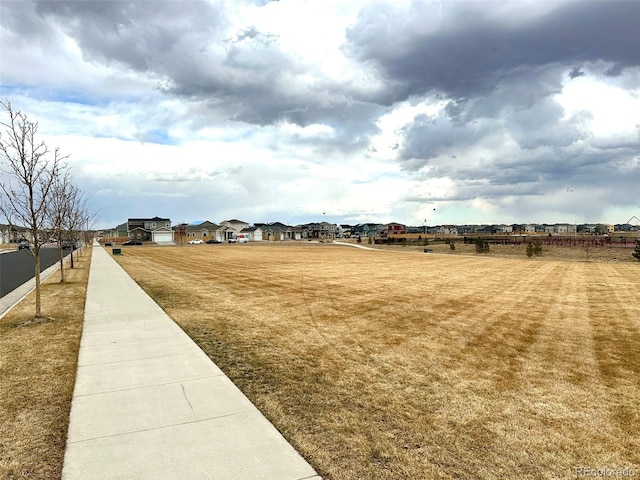 exterior space featuring a residential view and fence