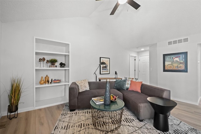6755 S Field St Unit 625, Littleton, CO 80128 - living room featuring wood finished floors, lofted ceiling, a ceiling fan, built in shelves, and baseboards
