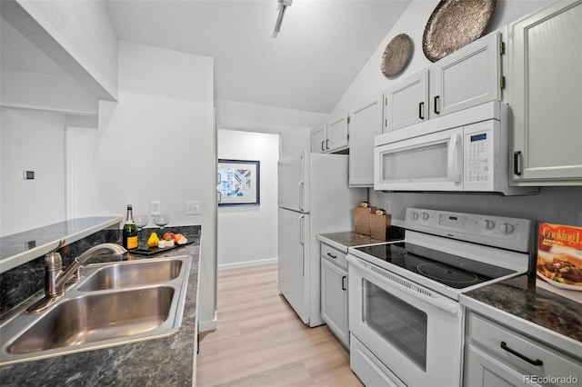 6755 S Field St Unit 625, Littleton, CO 80128 - kitchen with white appliances, a sink, dark countertops, light wood finished floors, and lofted ceiling