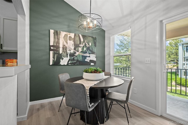 6755 S Field St Unit 625, Littleton, CO 80128 - dining room featuring a chandelier, light wood-style floors, and baseboards