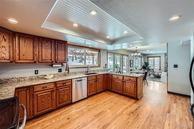 kitchen featuring brown cabinets, electric range, a raised ceiling, and dishwasher