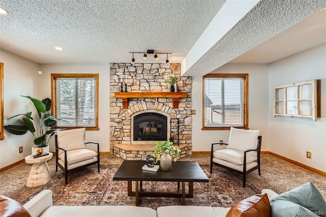 living room featuring a fireplace, baseboards, and a textured ceiling