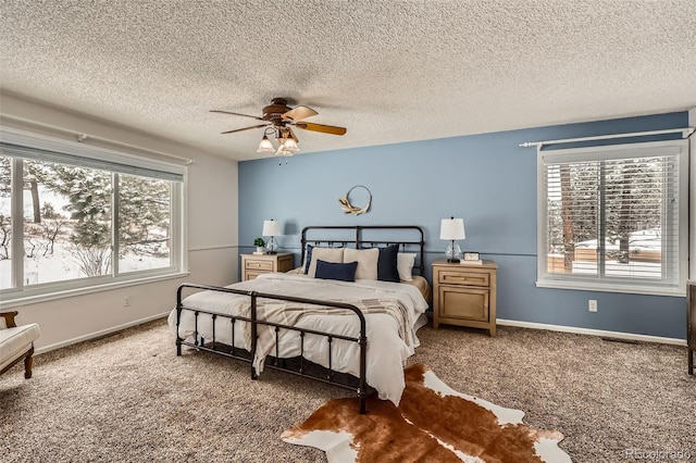 bedroom featuring carpet floors, multiple windows, and baseboards