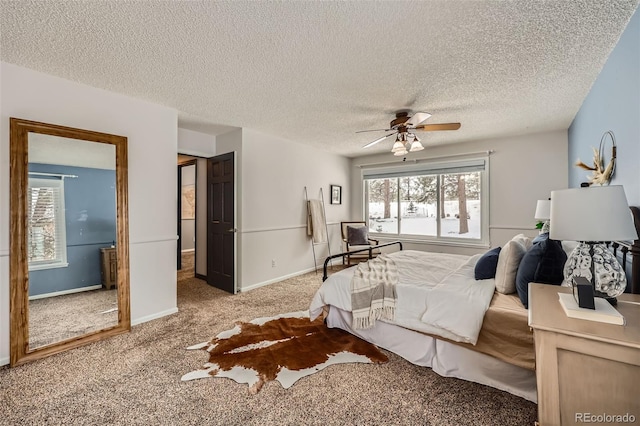 bedroom featuring light carpet, ceiling fan, baseboards, and a textured ceiling