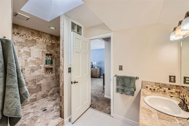 bathroom featuring baseboards, visible vents, vaulted ceiling, walk in shower, and vanity