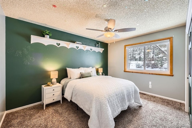 bedroom with a textured ceiling, carpet floors, and baseboards