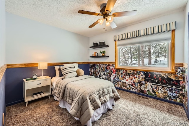 carpeted bedroom featuring a ceiling fan and a textured ceiling