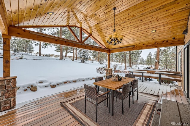 snow covered deck with outdoor dining space