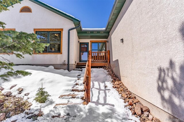 4860 County Road 140, Westcliffe, CO 81252 - snow covered property entrance with stucco siding