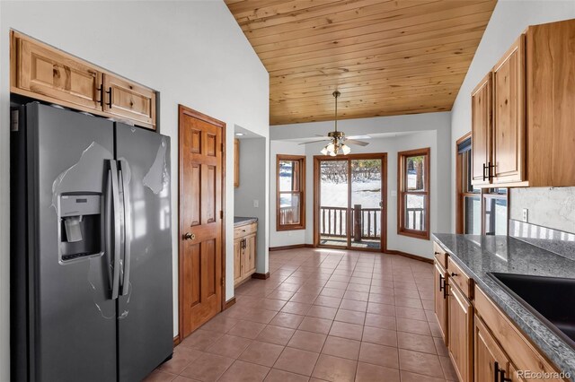 4860 County Road 140, Westcliffe, CO 81252 - kitchen with stainless steel fridge with ice dispenser, wood ceiling, tile patterned flooring, baseboards, and vaulted ceiling