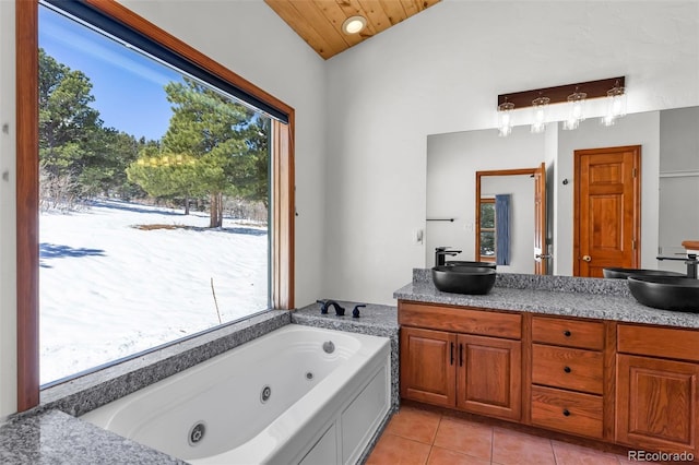 4860 County Road 140, Westcliffe, CO 81252 - bathroom with plenty of natural light, a tub with jets, double vanity, and tile patterned flooring