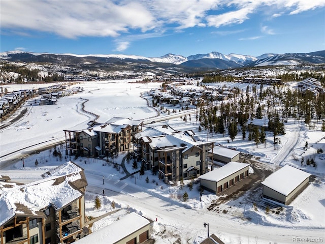 snowy aerial view with a mountain view