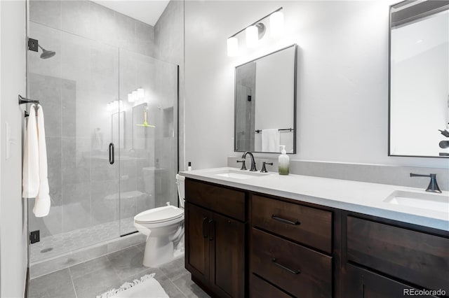 bathroom with tile patterned flooring, vanity, an enclosed shower, and toilet