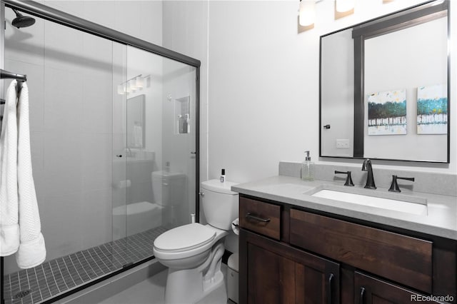 bathroom with vanity, toilet, and an enclosed shower