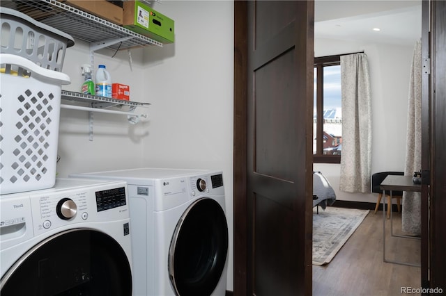 laundry room featuring wood-type flooring and independent washer and dryer