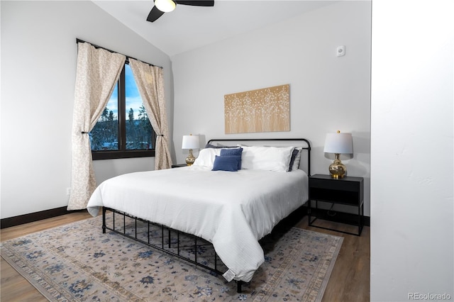 bedroom featuring vaulted ceiling, wood-type flooring, and ceiling fan