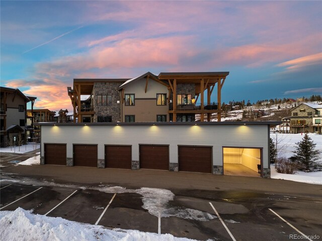 16 Springview Ln Unit A 304, Fraser, CO 80442 - view of front of home with stone siding, community garages, and a balcony
