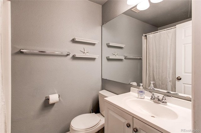 1128 S Ventura Cir Unit K, Aurora, CO 80017 - bathroom featuring vanity, toilet, and a shower with shower curtain