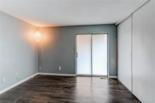 1128 S Ventura Cir Unit K, Aurora, CO 80017 - unfurnished room with wood finished floors, a textured ceiling, and baseboards