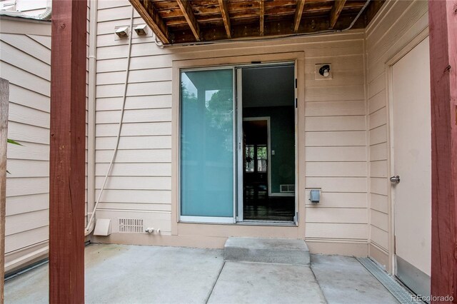 1128 S Ventura Cir Unit K, Aurora, CO 80017 - view of exterior entry featuring a patio