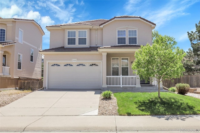 traditional home featuring covered porch, fence, a garage, concrete driveway, and stucco siding