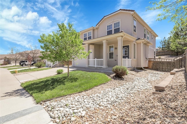 view of front of house featuring covered porch, driveway, fence, and stucco siding