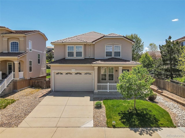 traditional-style home featuring fence, a porch, a garage, concrete driveway, and a tile roof