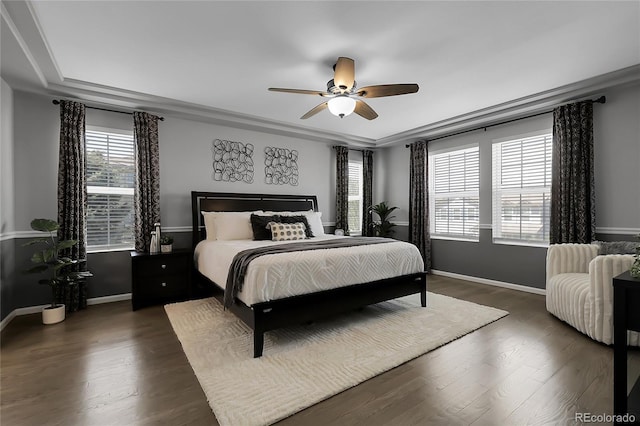 bedroom with multiple windows, dark wood-style floors, and baseboards
