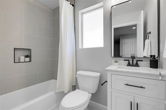 bathroom with toilet, baseboards, vanity, and shower / bath combo
