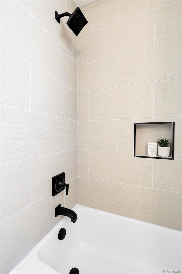bathroom featuring washtub / shower combination