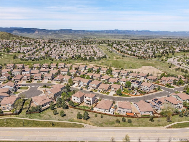 aerial overview of property's location with nearby suburban area and a mountainous background