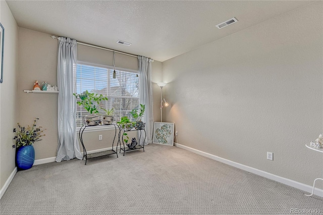 sitting room featuring baseboards and carpet flooring