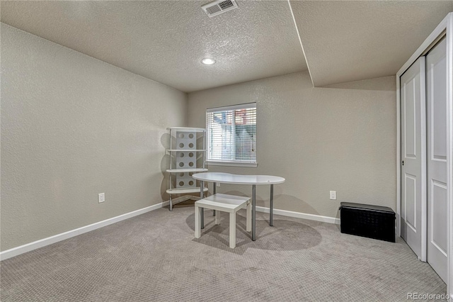 carpeted office featuring a textured ceiling, a textured wall, and baseboards