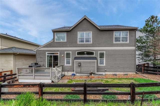 back of house featuring a deck and a fenced backyard