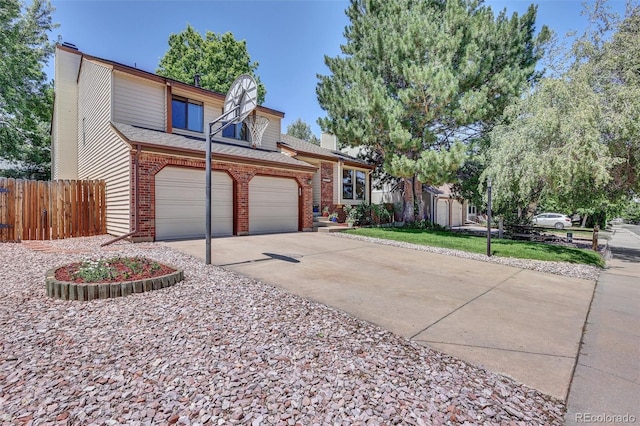 14463 E Wagon Trail Pl, Aurora, CO 80015 - view of front of house featuring a chimney, concrete driveway, brick siding, and roof with shingles