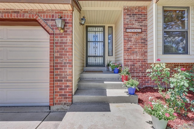 14463 E Wagon Trail Pl, Aurora, CO 80015 - property entrance featuring brick siding and a garage