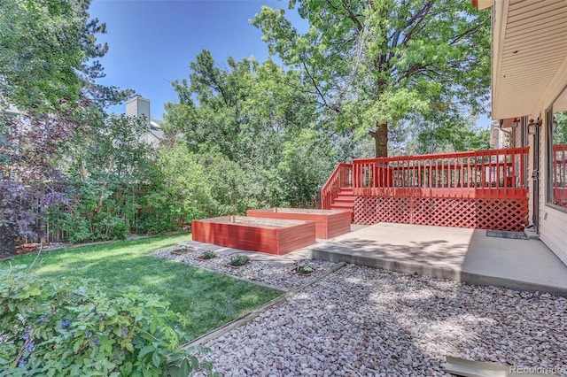 14463 E Wagon Trail Pl, Aurora, CO 80015 - view of grassy yard with a garden, a wooden deck, and a patio