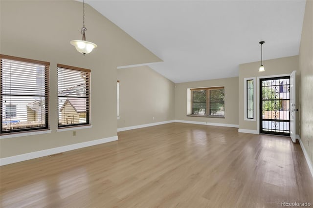 14463 E Wagon Trail Pl, Aurora, CO 80015 - unfurnished living room featuring light wood finished floors and high vaulted ceiling