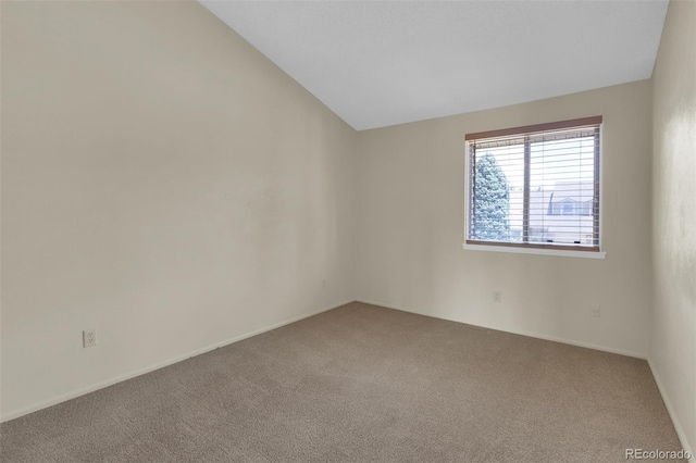 14463 E Wagon Trail Pl, Aurora, CO 80015 - carpeted empty room featuring lofted ceiling and baseboards
