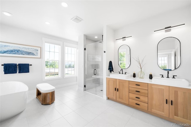 8357 W 68th Ln, Arvada, CO 80004 - full bathroom with a stall shower, double vanity, a freestanding bath, recessed lighting, and tile patterned floors